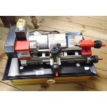 An Emco UniMat 4 lathe, set on a custom made drawer base, with manual and DVD