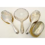 A silver backed three piece hand mirror and brush set - sold with another silver mounted brush