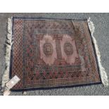 A small Persian mat with two central medallions within geometric borders and panel ends, pink,