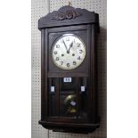 An early 20th Century stained oak cased wall clock with bevelled part glazed door and Mauthe eight