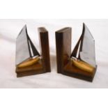 A pair of vintage book pattern oak bookends mounted with chrome and painted pine yachts