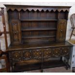 A 6' stained oak two part dresser in the antique style with three open shelves, flanking shelves and