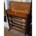 A 31" early 20th Century stained oak and mixed wood shoe rack with lift-top compartment to top,