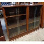 A 3' 3" mid 20th Century stained oak bookcase with adjustable shelves enclosed by two pairs of glass