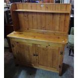 A 3' 5" modern waxed pine dresser with shelf to raised back, over a base with two panelled