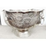 A large Pinder Bros. silver plated pedestal punch bowl with embossed decoration and flanking lion