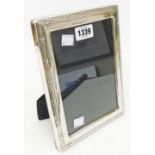 A modern silver fronted photograph frame with upholstered easel back - to take 7" X 5" - Sheffield