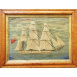 An antique woolwork of a full-rigged ship at sea, in a maple frame
