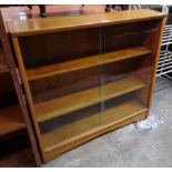 A 35" retro teak bookcase by Herbert E. Gibbs with three shelves enclosed by a pair of glass sliding