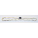 A single string of uniform sized cultured pearls with white metal clasp