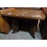 A 3' 6" 20th Century stained wood draw-leaf dining table, set on panelled and canted standard ends