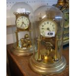 An early 20th Century anniversary clock with disc pendulum and glass dome - sold with another with
