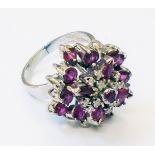 A high carat white metal ruby and diamond cluster ring