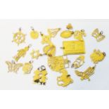 A collection of American marked 14k pressed yellow metal charms