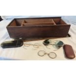 A stained wood box containing a cased pair of pince nez, a cased pair of Windsor USA yellow metal