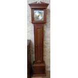 A stained wood cased reproduction grandmother clock with storage to trunk and battery timepiece