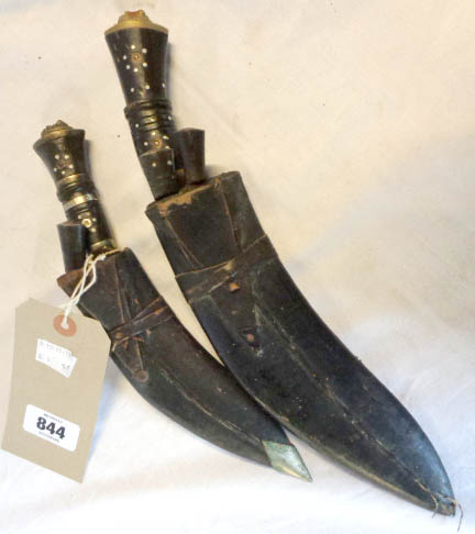 Two souvenir kukri knives in leather scabbards