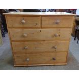 A 3' 7" Victorian waxed pine chest of two short and three long graduated drawers with turned wood