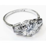 A 1930's Art Deco marked platino ring, set with central 2ct. diamond and six flanking baguette
