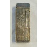 A vintage white metal Dunhill Rollagas lighter