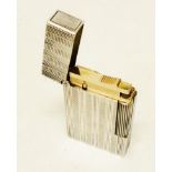 A Dupont gentleman's white metal cased lighter with banded engine turned and ribbed decoration -