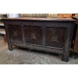 A 4' 2" antique oak three panel coffer with decorative carving to front, set on simple block feet