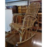 An old canework hoop back rocking chair