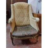 An Edwardian part show frame drawing room armchair with remains of original upholstery and later