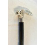 A walking stick with white metal hare's head top