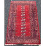 An antique handmade red Bokhara rug with single row of twelve guls - 4' 9" X 36" (147cm X 91cm)