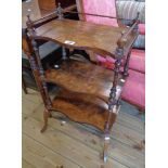 An 18" late 19th Century stained wood three tier what-not with stencilled decoration to serpentine