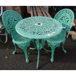 A cast aluminium circular table and pair of chairs