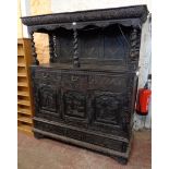 A 5' Victorian heavily carved stained oak buffet cabinet with decorative open top and barley twist