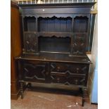 A 4' 6" early 20th Century stained oak two part dresser in the antique style with moulded top,