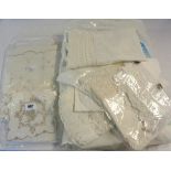A large collection of linen and crochet edged items including tablecloths, etc.