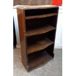 A 21" 20th Century oak break bow front four shelf open bookcase