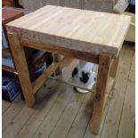 A 34" modern pine thick sectional top butcher's block, set on a rustic stained wood base with square