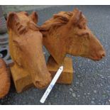 A pair of cast iron horse heads with rust finish
