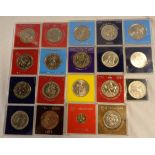 A collection of cased coins including 1887 US Morgan Dollar, 1977 New Zealand Dollar, 1979 Isle of