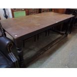 A 6' 6 1/2" antique oak refectory dining table, set on turned supports and all-round foot rail