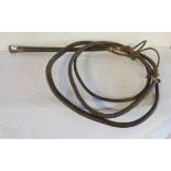 A vintage braided leather hunting whip