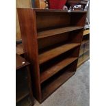 A 3' 3" vintage stained wood four shelf open bookcase