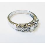An 18ct. white gold Cavill ring, set with central oblong diamond flanked by further collar and