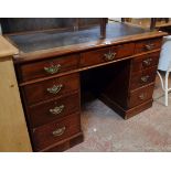 A 4' Edwardian mahogany twin pedestal desk with leather inset top, three frieze drawers and six