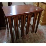A retro stained mixed wood coffee table with four nesting folding framed tea tables