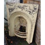 A Victorian cast iron arched fireplace insert