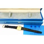 A boxed Garrard 9ct. gold cased unisex wristwatch with square gilt dial, leather strap and quartz