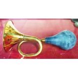 A reproduction brass car horn