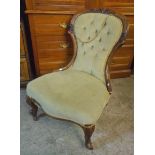 A Victorian walnut part show frame spoon back nursing chair with frosted green upholstery, set on