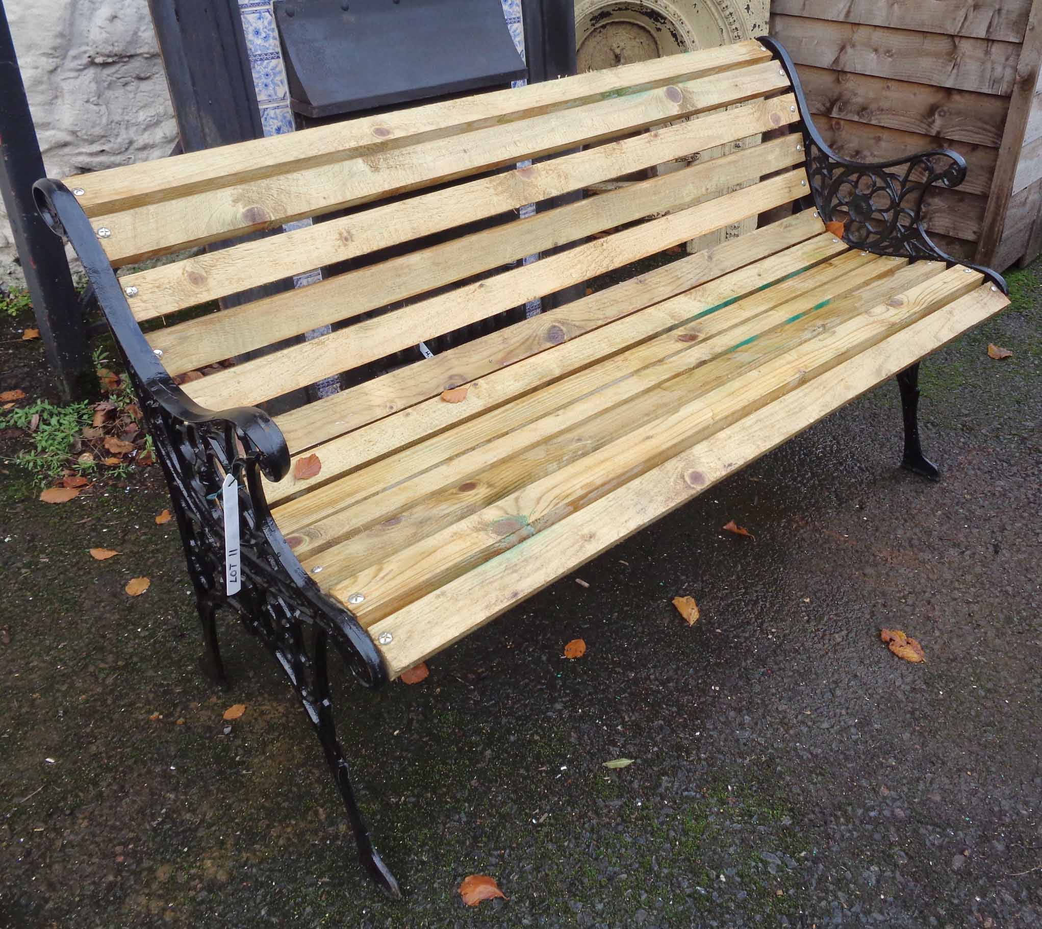 A garden bench with cast iron supports and slatted seat